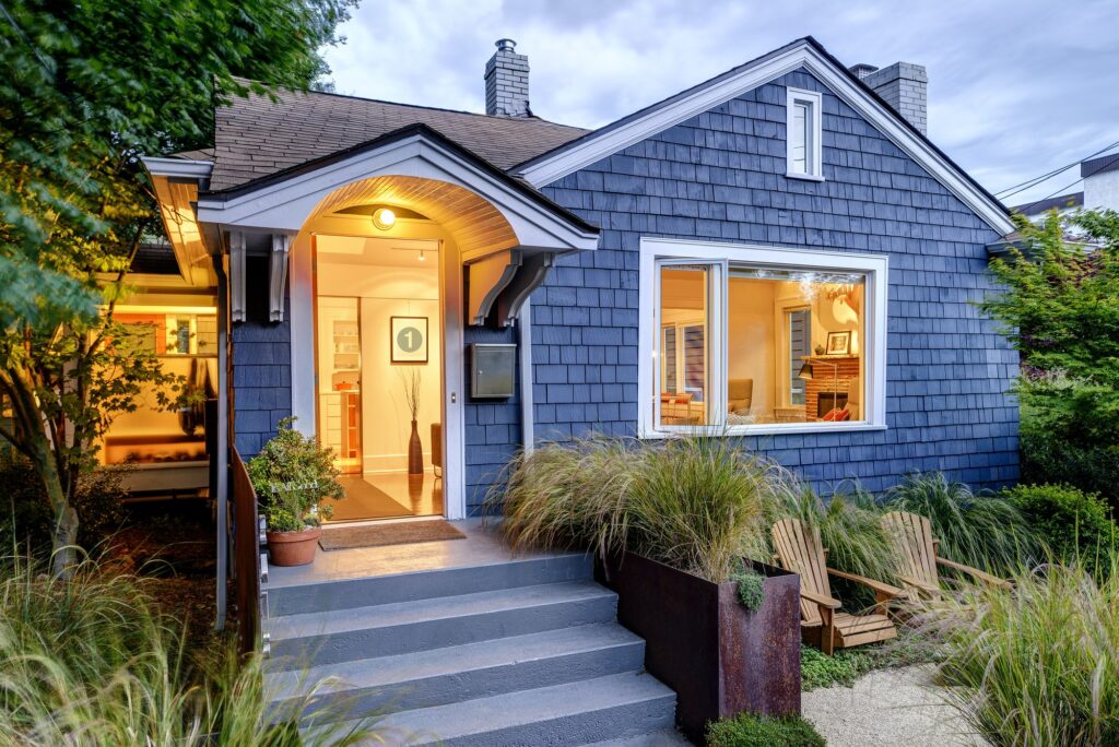 Illuminated front stoop and of blue house